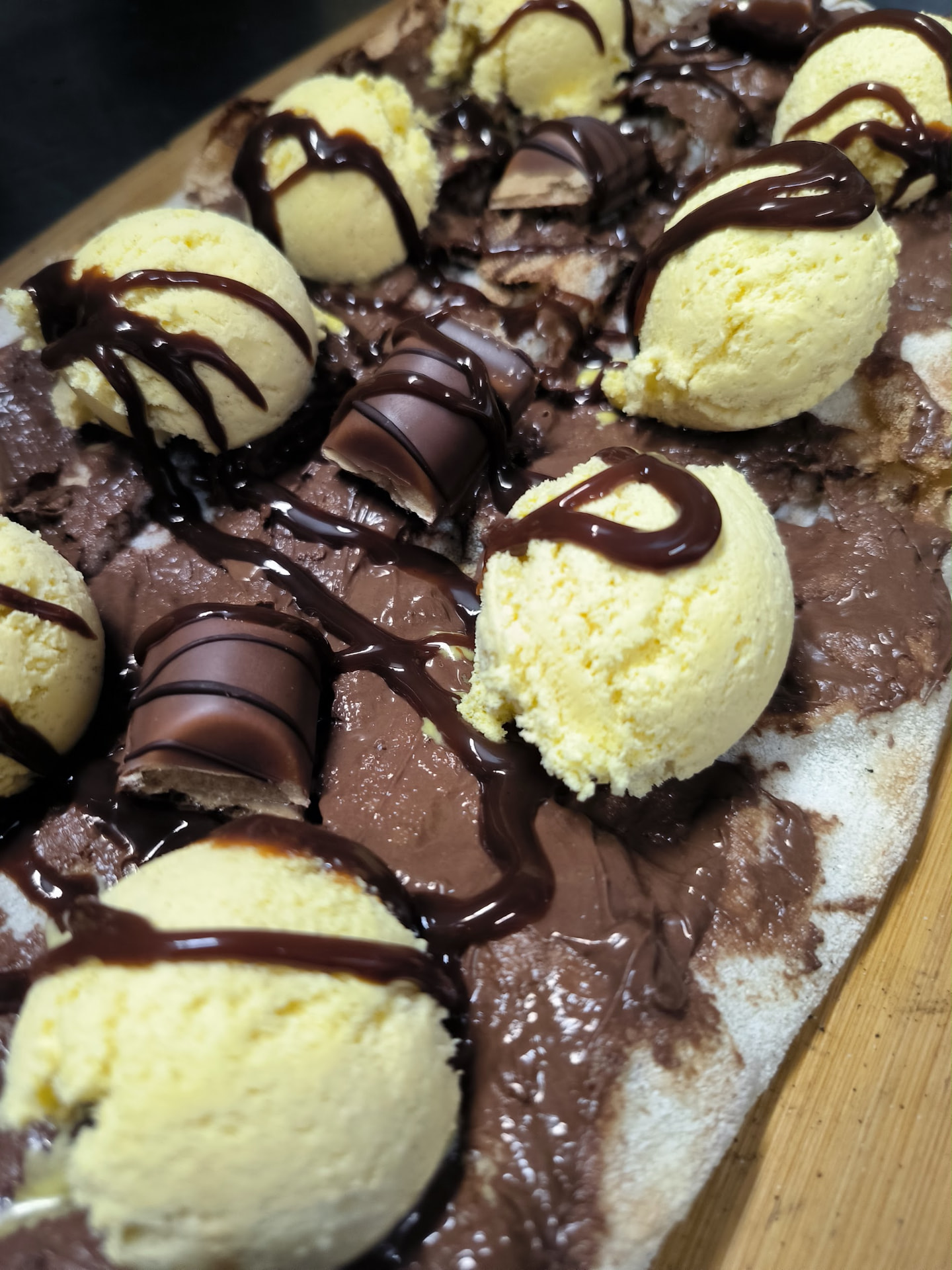Pizza dolce con crema al cioccolato, gelato e cioccolatini